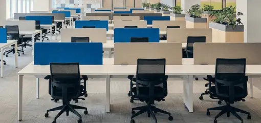 Modern open-plan office space featuring clean workstations, ergonomic chairs, and sanitized carpets provided by professional office cleaning services in Evansville, IN.